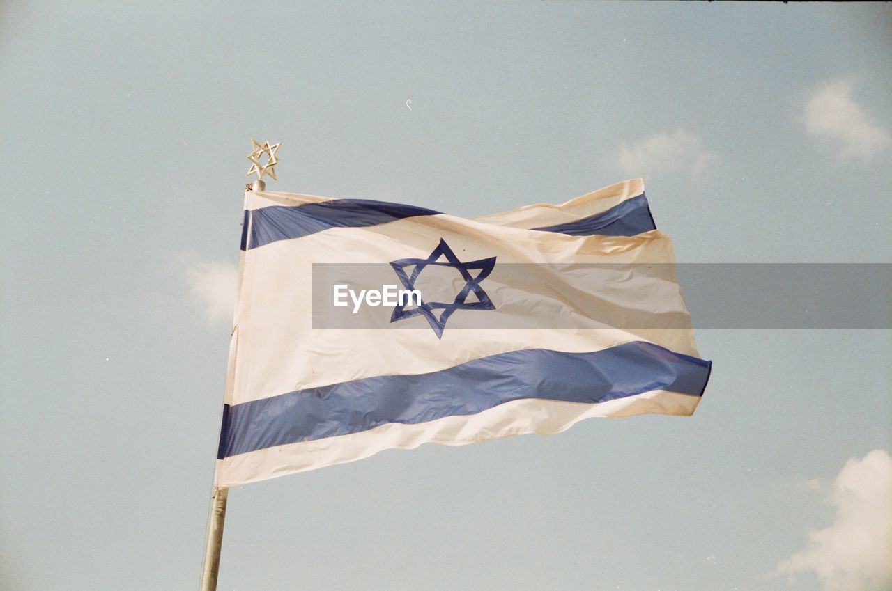 Low angle view of israeli flag against sky