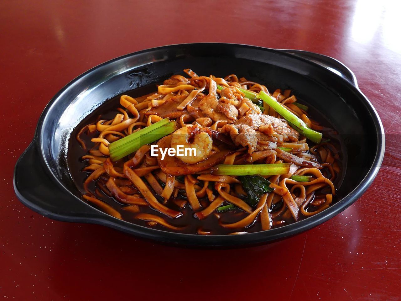 Close-up of prawn noodles in plate on table