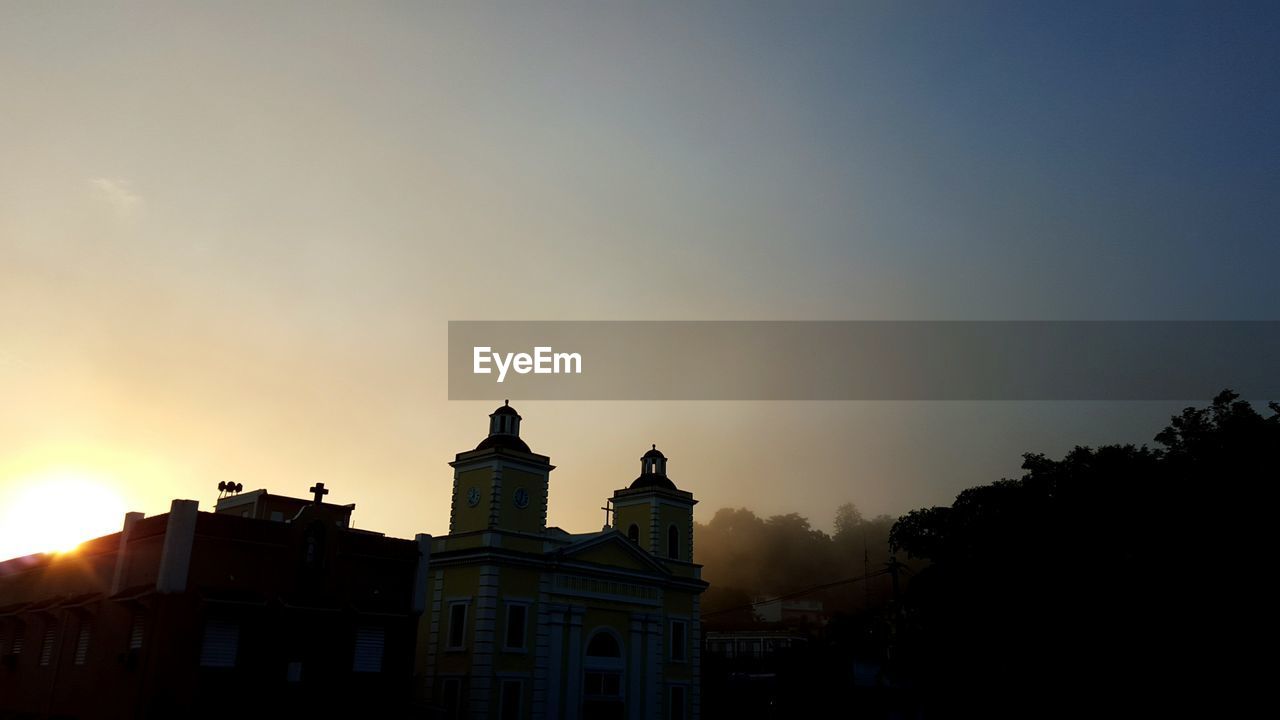 Historic building against clear sky during sunset