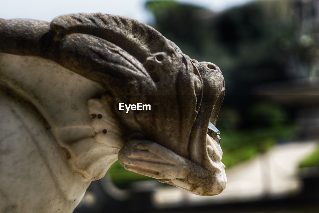 CLOSE-UP OF STATUE AGAINST CLEAR SKY