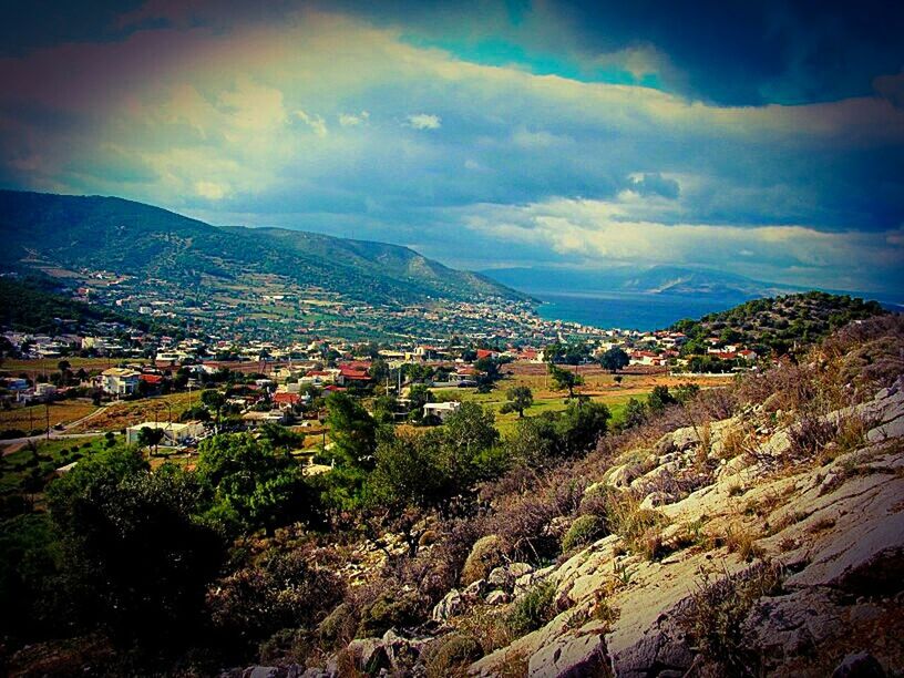 TOWNSCAPE AGAINST CLOUDY SKY