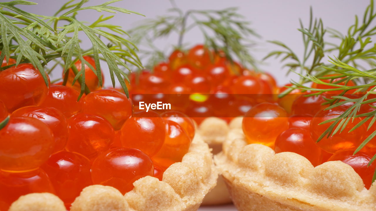 Close-up of red caviar on white background