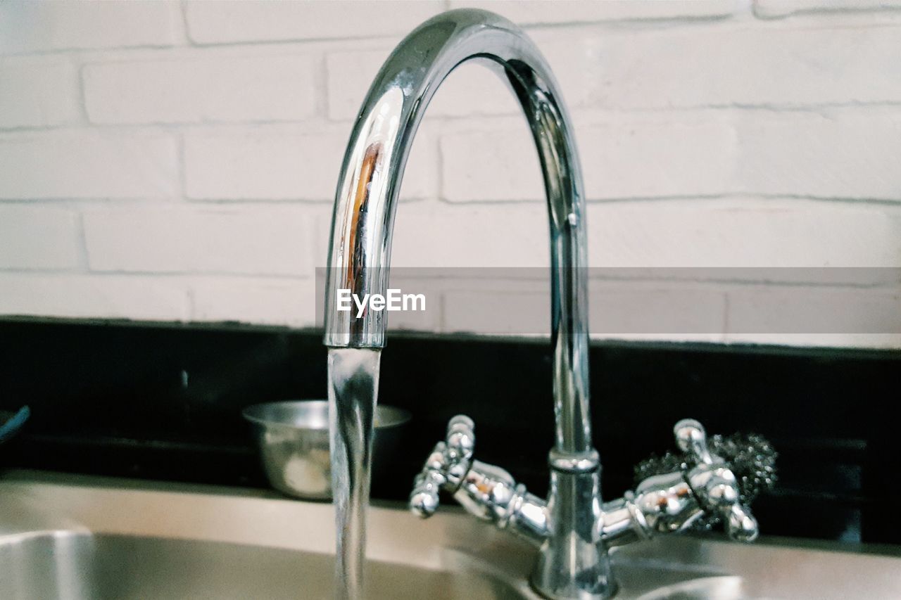 Close-up of running water from faucet in kitchen sink