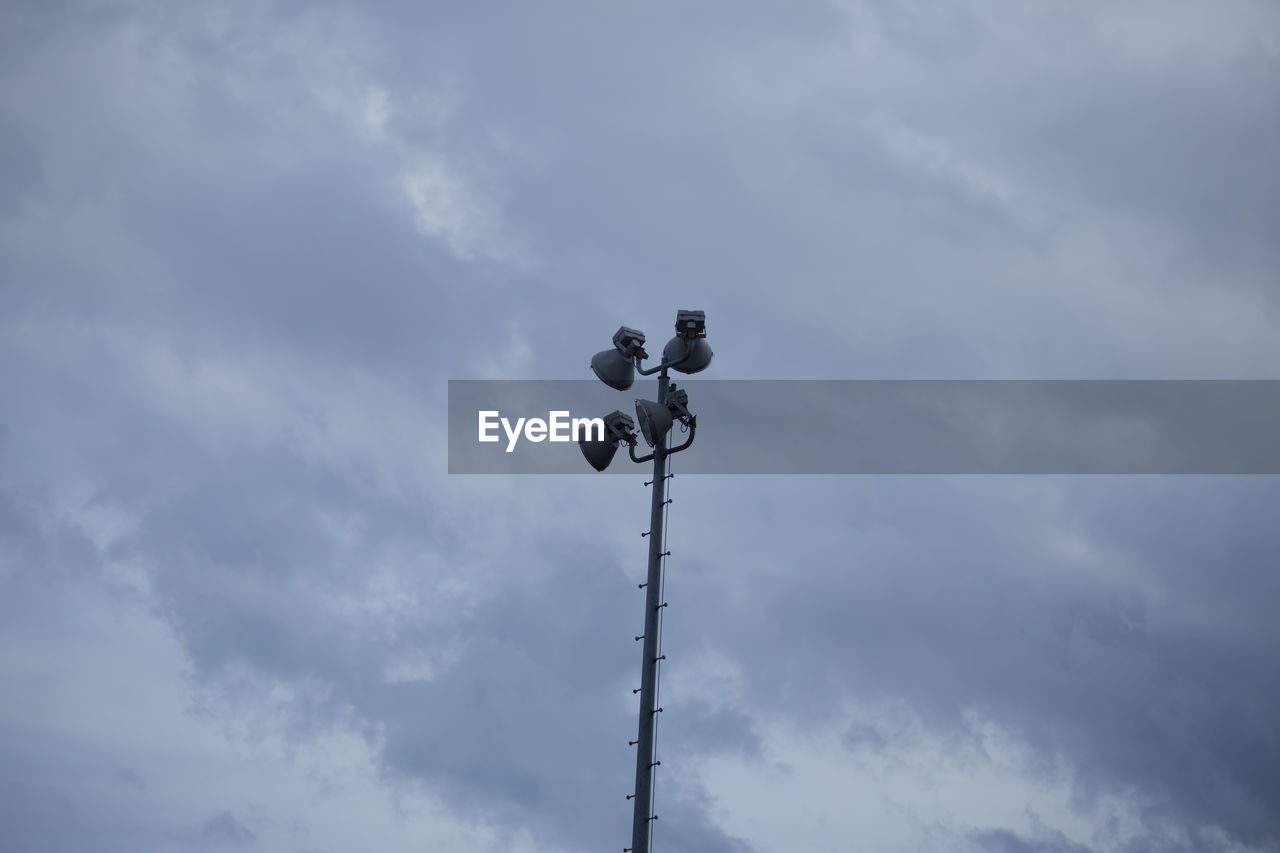 Field lights against a dark, dreary, grey sky