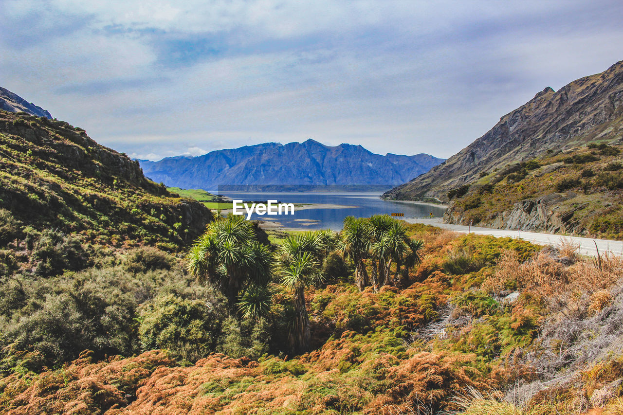 Scenic view of lake and mountains against sky