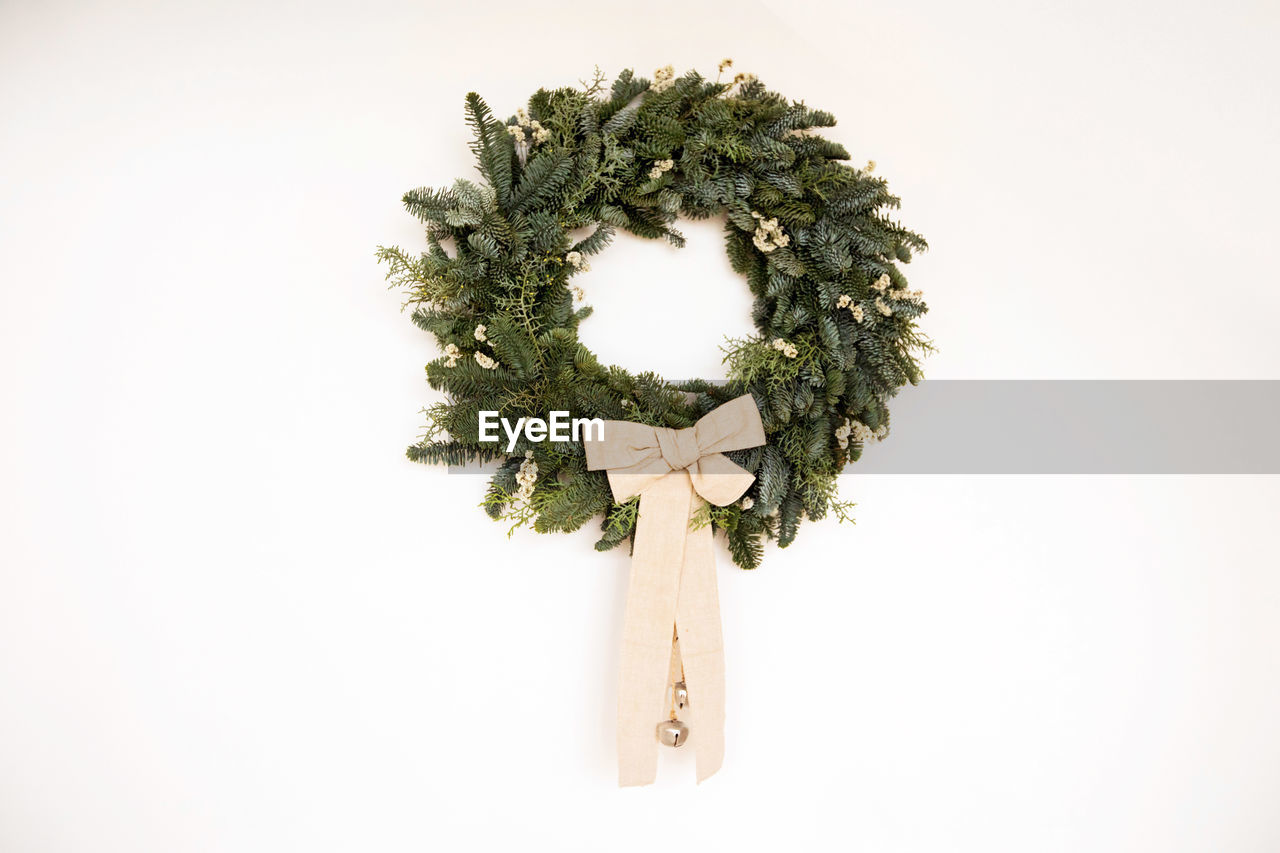 Christmas wreath on white wall