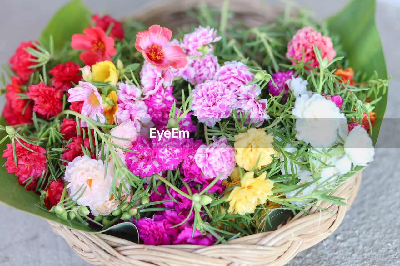 HIGH ANGLE VIEW OF VARIOUS FLOWERS ON BASKET