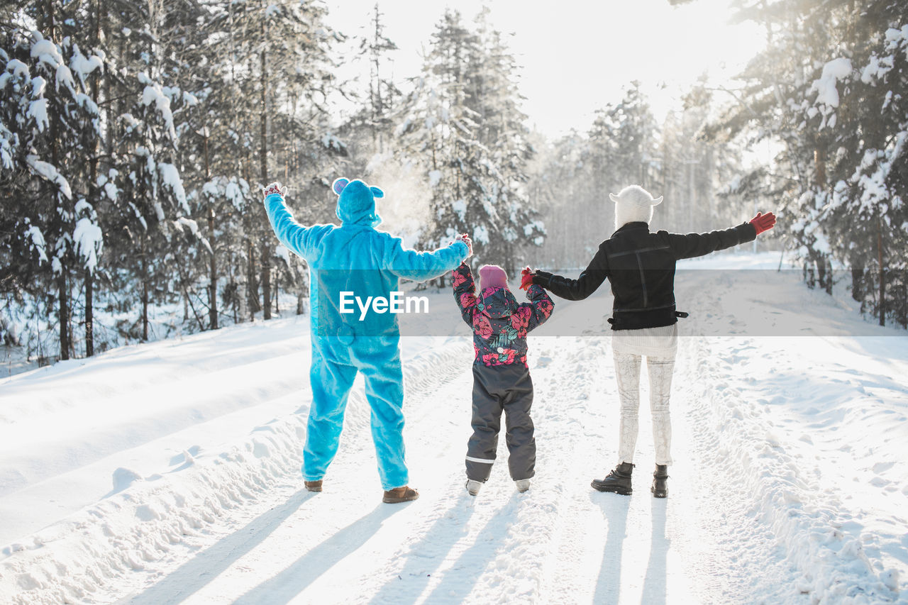 Full length of family on snow covered field