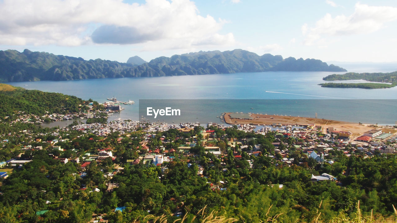 Scenic view of sea and cityscape against sky