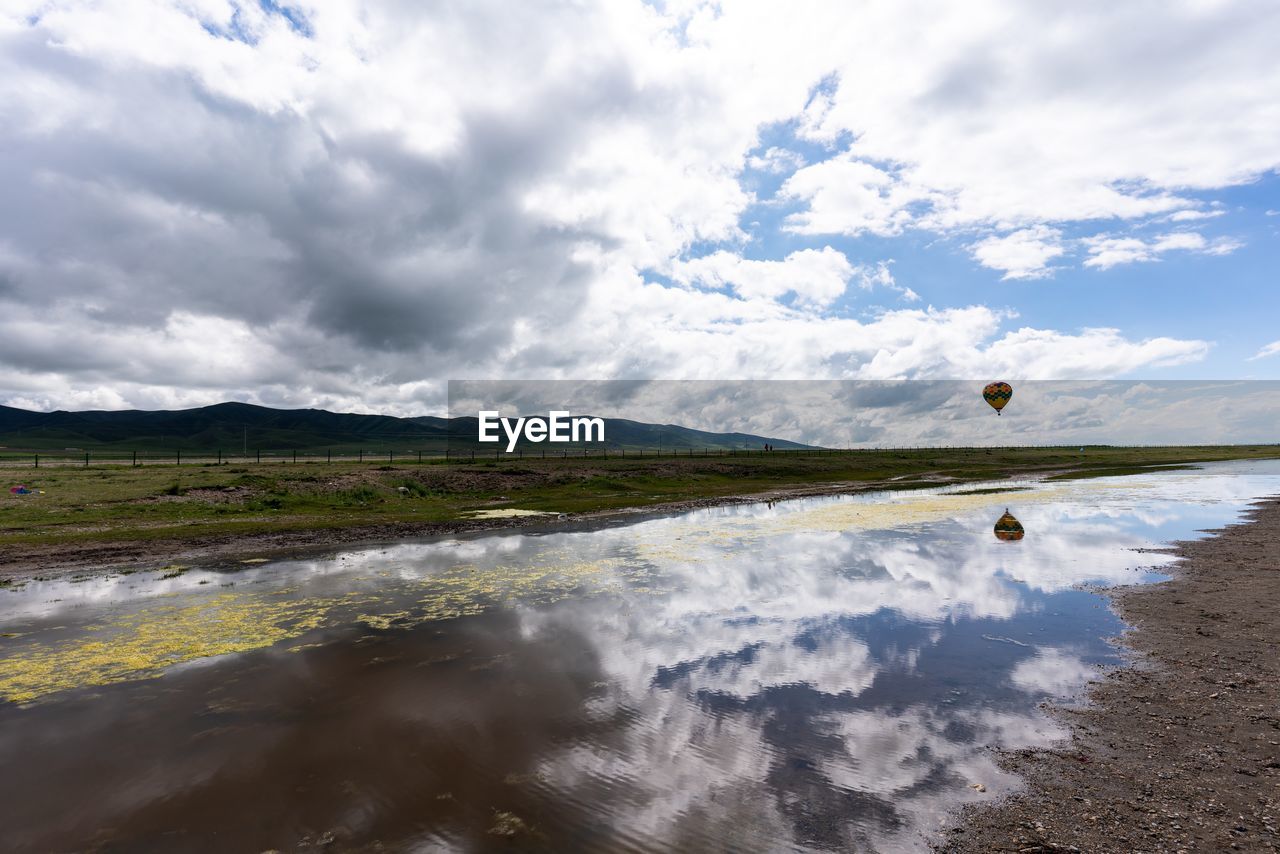 SCENIC VIEW OF LAND AND SEA AGAINST SKY