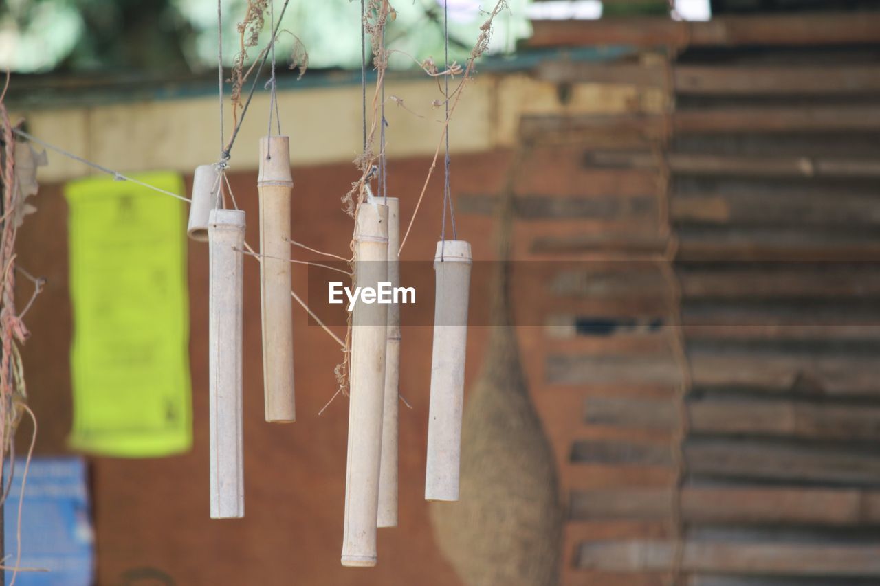 CLOSE-UP OF CLOTHESPINS HANGING ON STRING