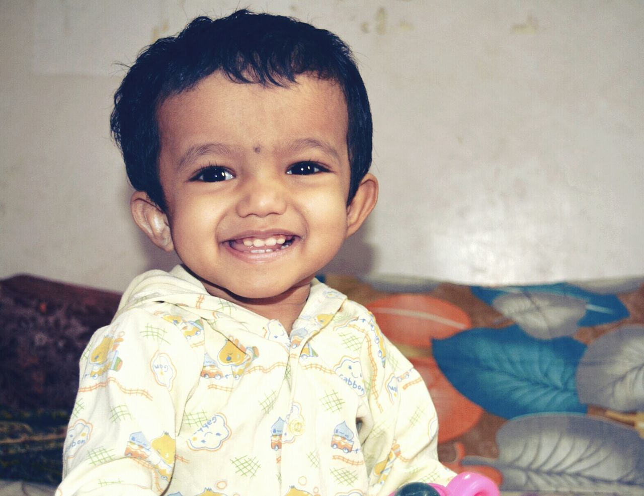 Close-up portrait of happy boy at home