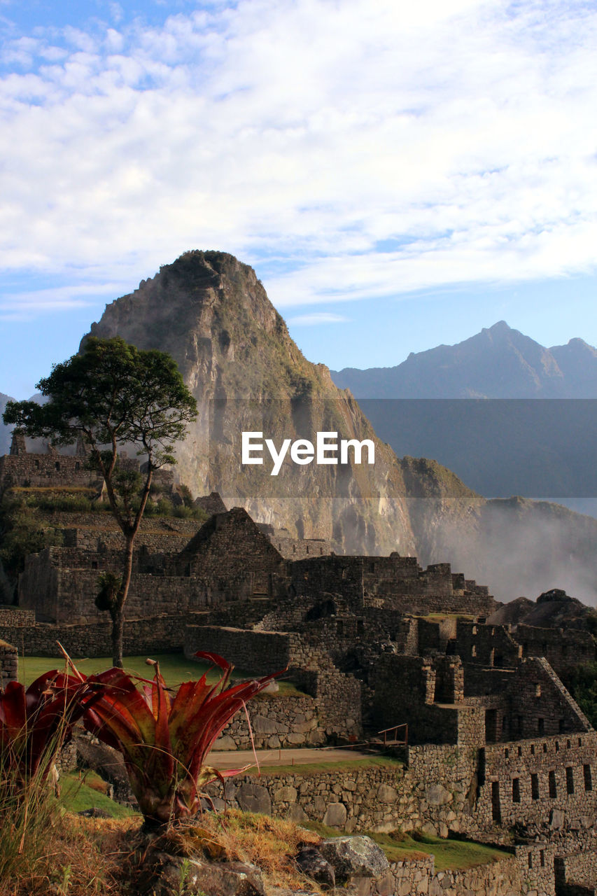 Scenic view of mountain against cloudy sky