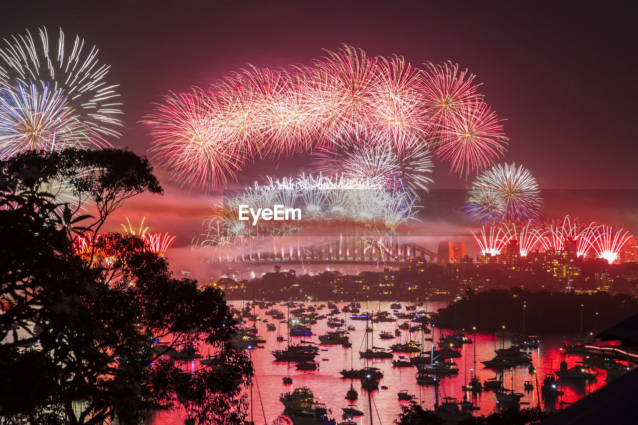 Firework display over sea at night