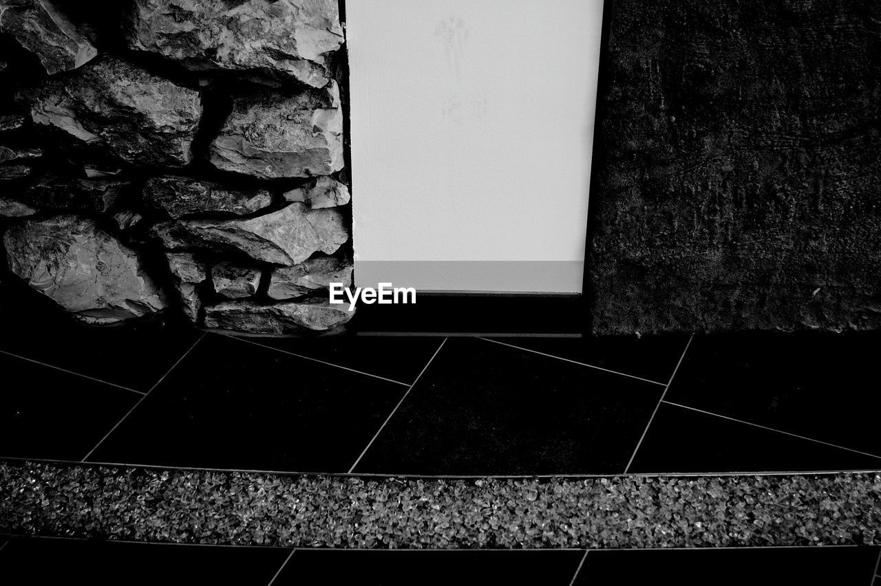 HIGH ANGLE VIEW OF TILED WALL WITH FLOOR