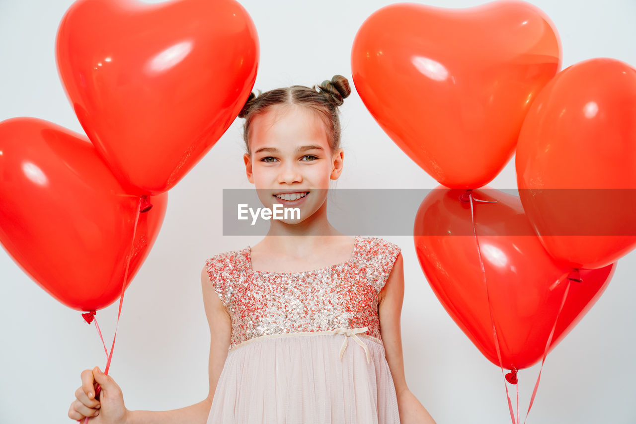 Portrait of woman with red balloon