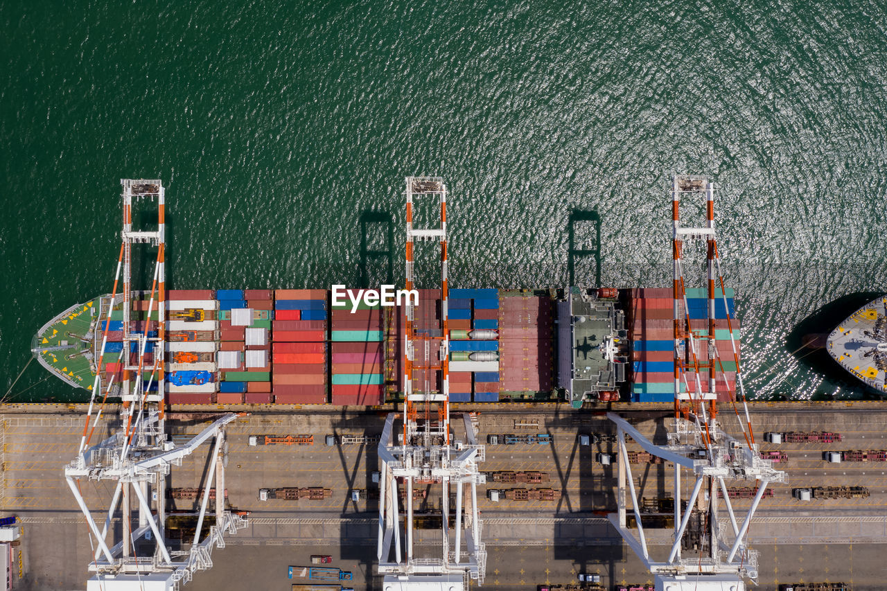 Container ship terminal, and quay crane of container ship at industrial port with shipping container 