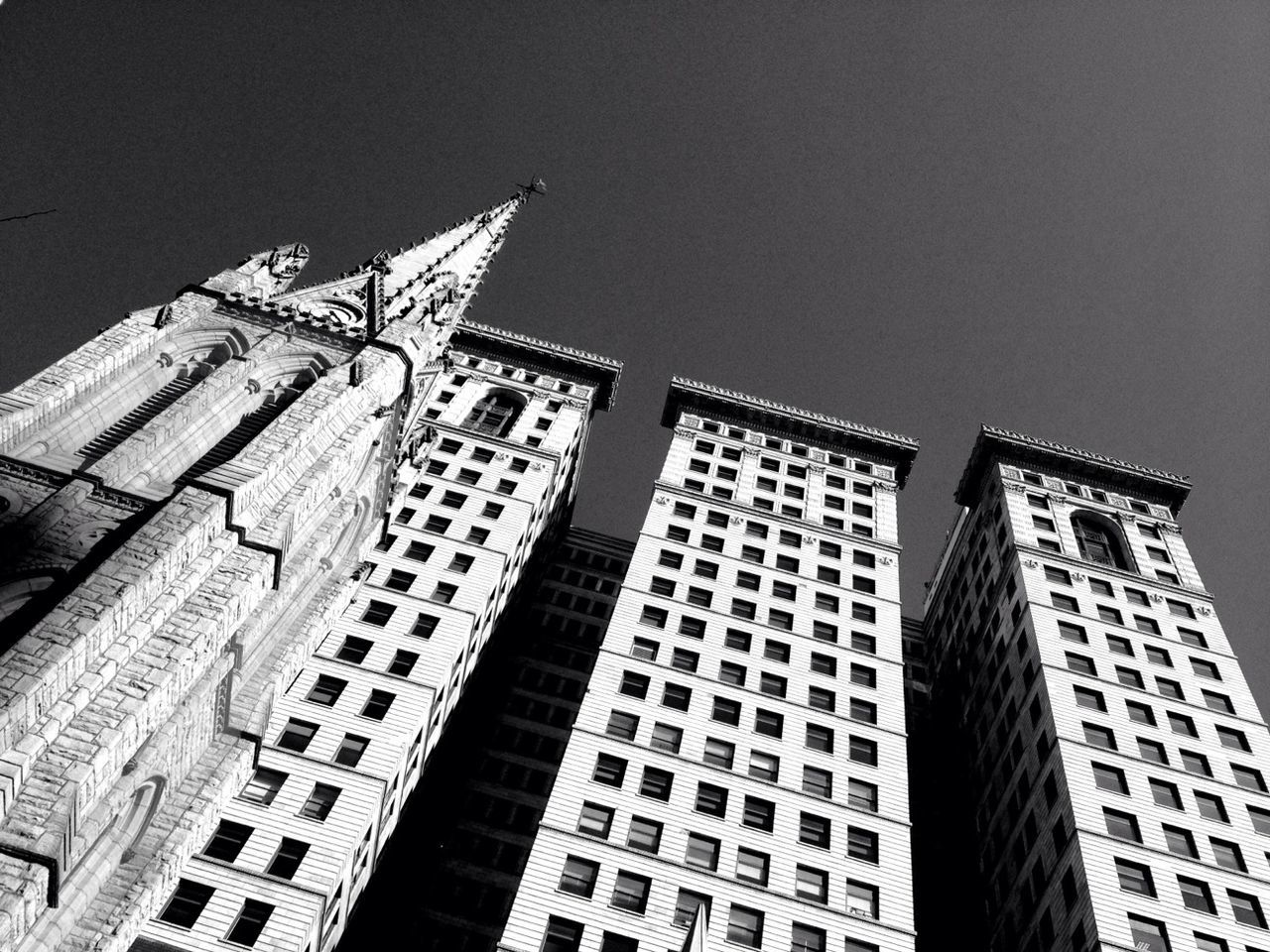 Low angle view of church and buildings against clear sky