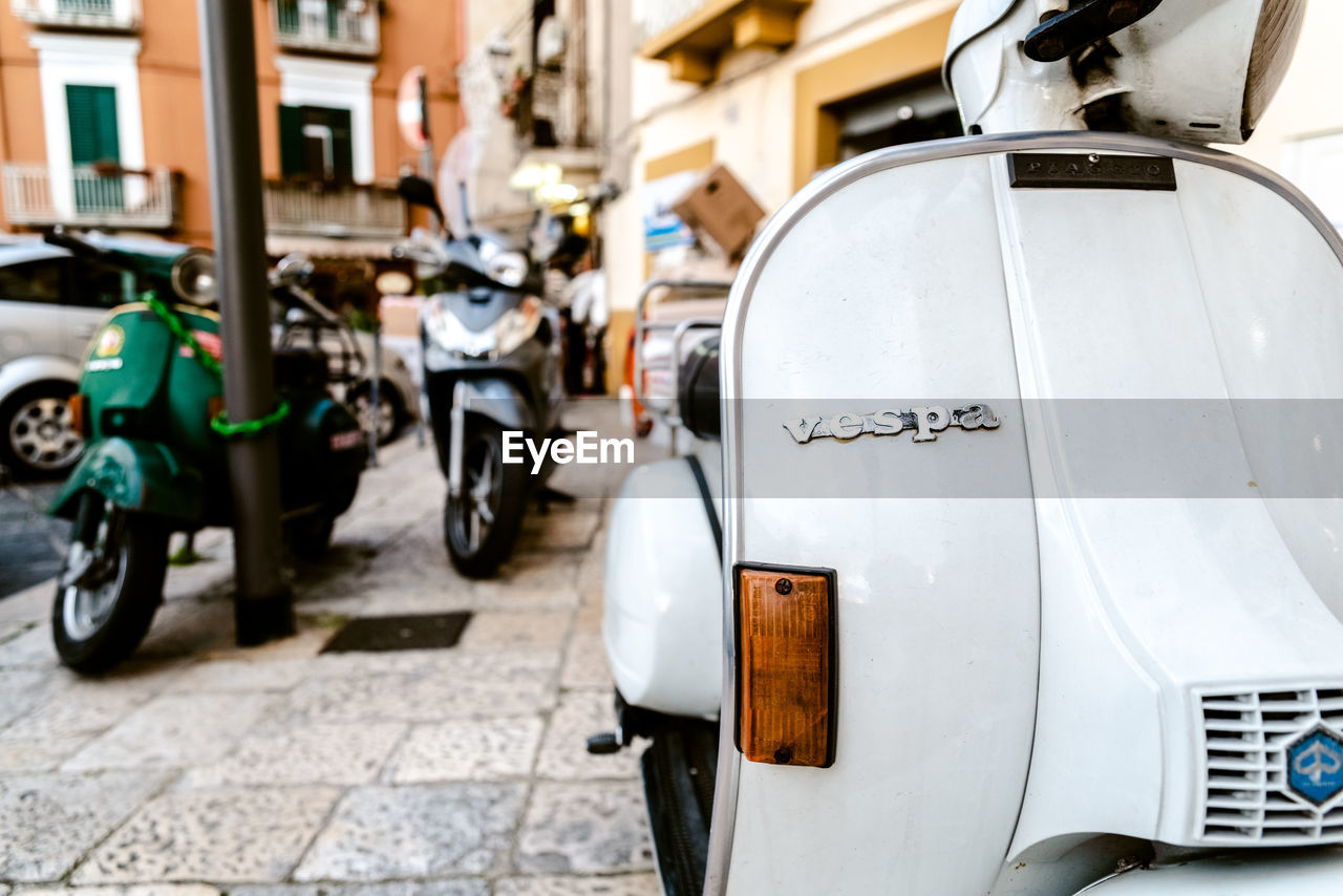 VIEW OF CARS PARKED ON STREET IN CITY