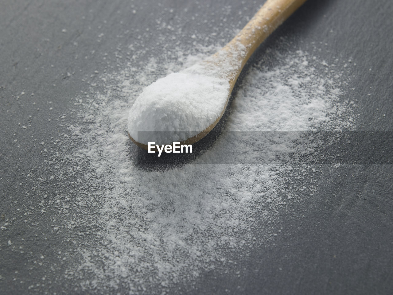 Close-up of powdered sugar in spoon on table