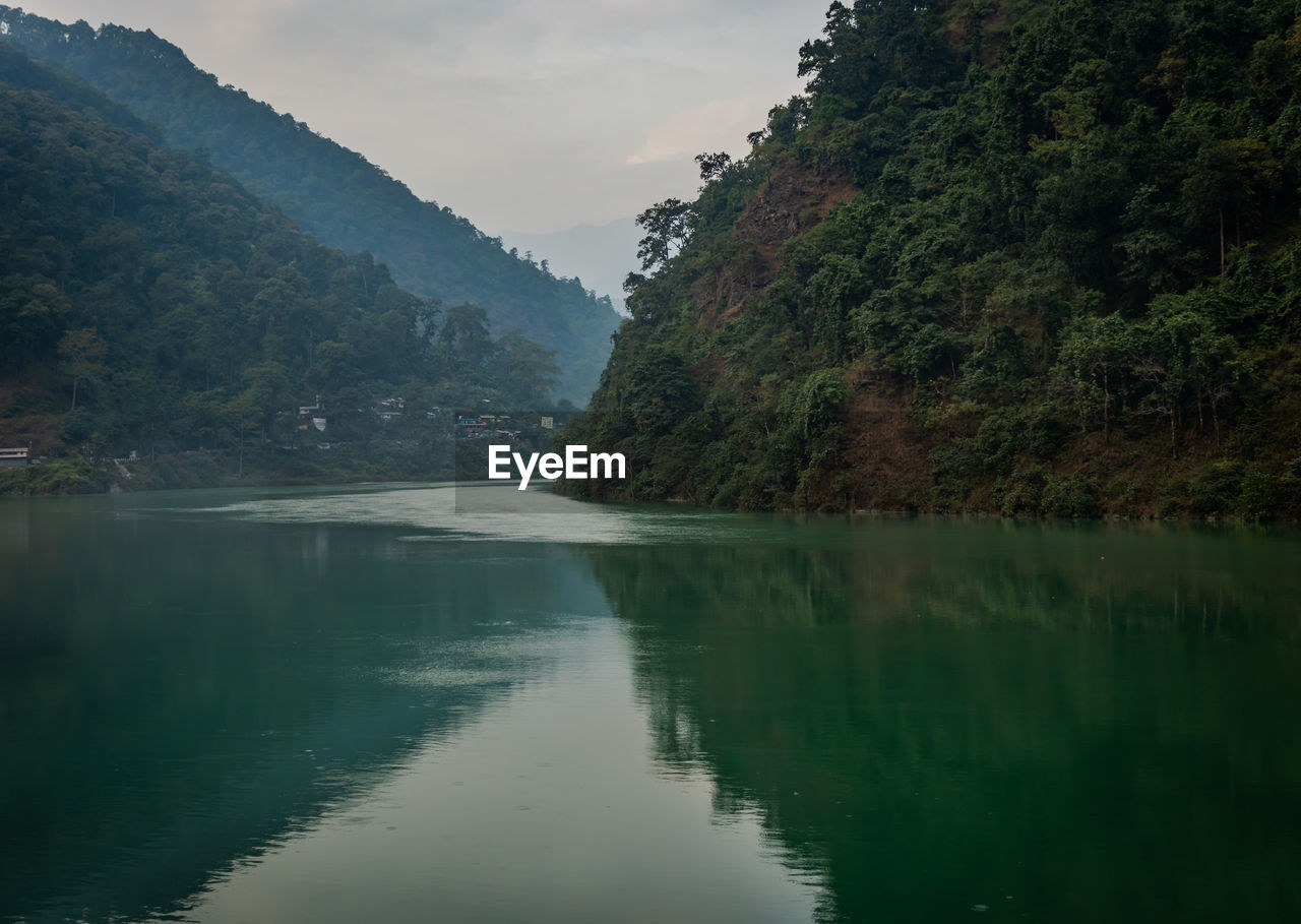 Scenic view of lake in forest at morning with reflection