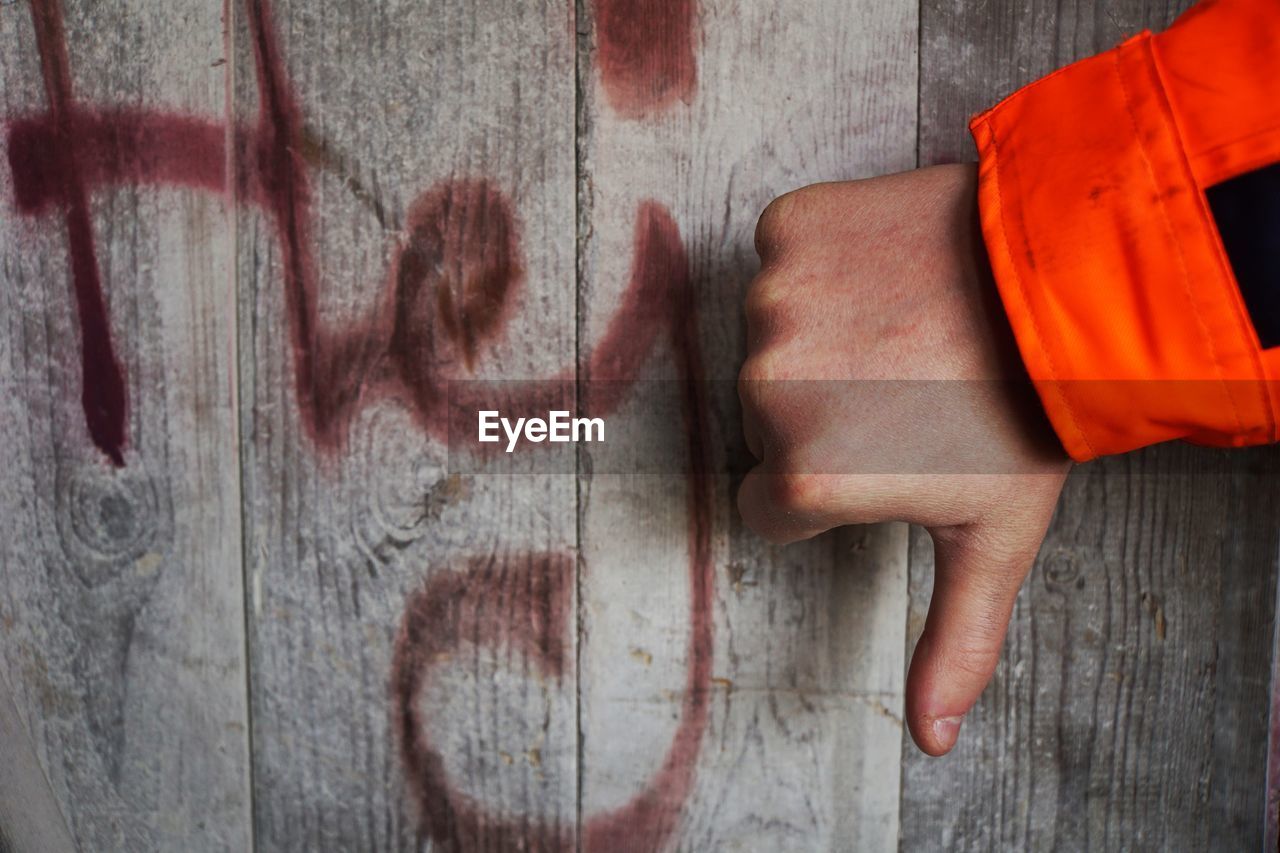 CLOSE-UP OF HAND ON WALL