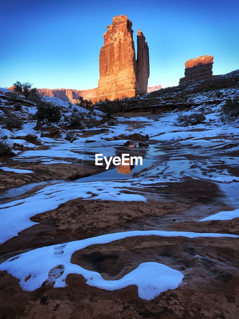 Scenic view of rock formation against sky during winter