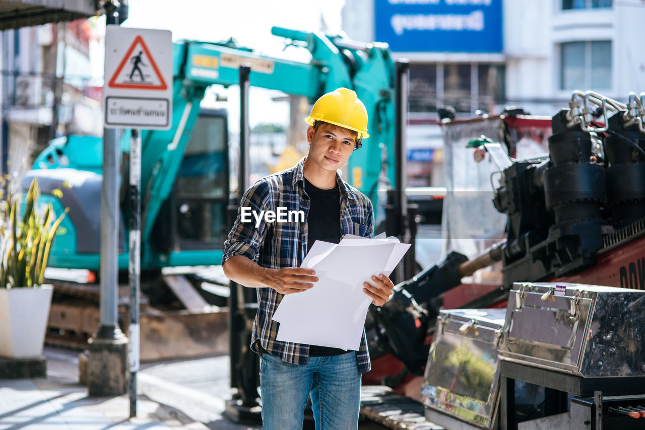 LOW ANGLE VIEW OF MAN WORKING WITH TEXT