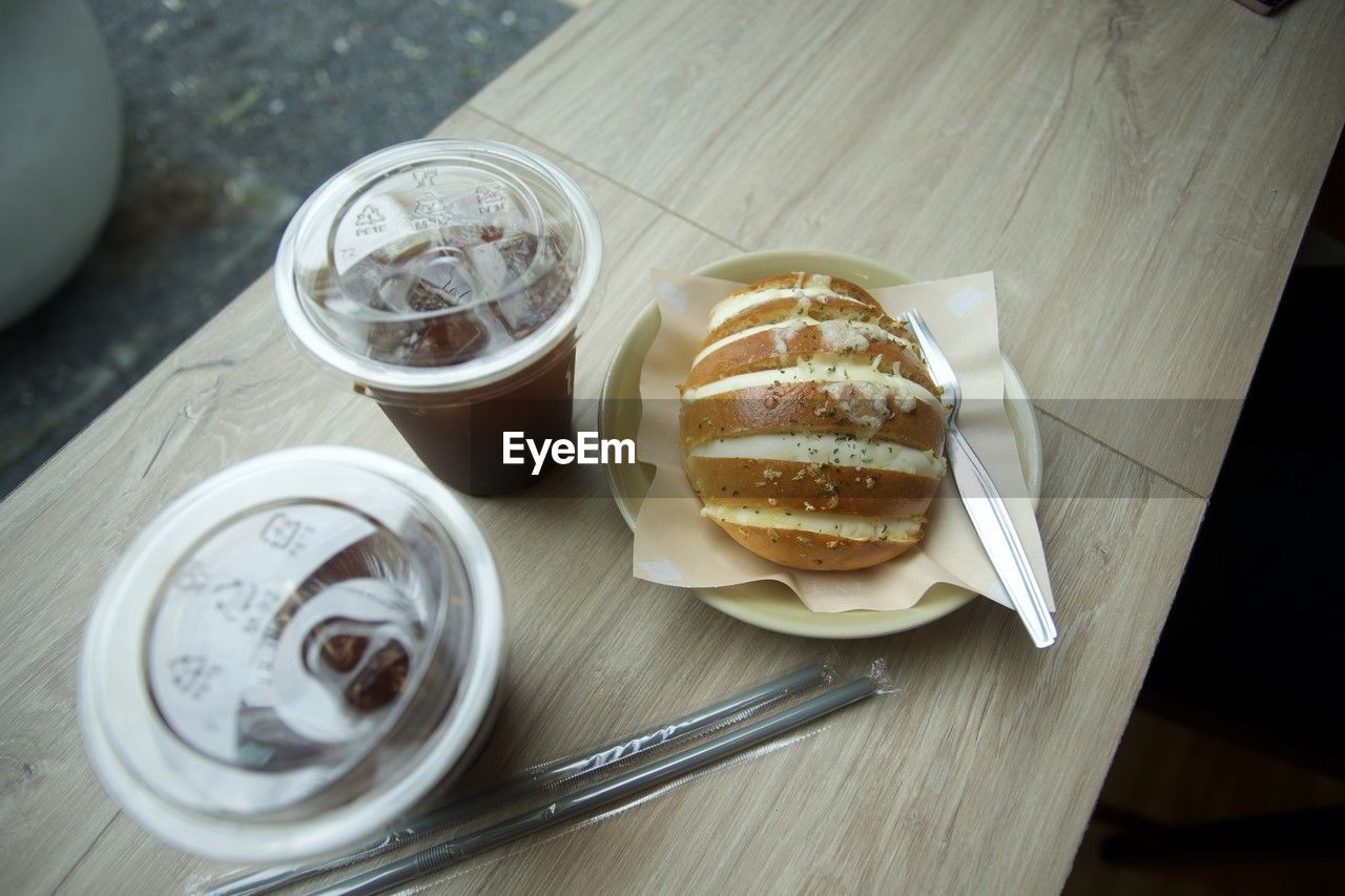 food and drink, food, high angle view, meal, freshness, table, drink, breakfast, sweet food, baked, refreshment, indoors, eating utensil, no people, still life, dessert, wood, sweet, kitchen utensil, plate, household equipment, drinking glass, unhealthy eating, dish, glass, coffee, fast food, dairy, cup, produce, bread
