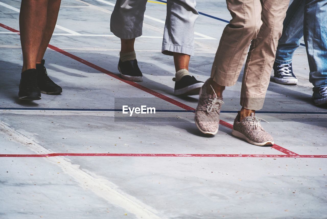 Low section of people walking on road