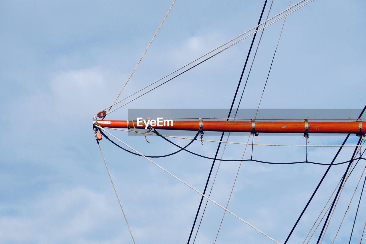 LOW ANGLE VIEW OF SAILBOAT AGAINST BRIDGE