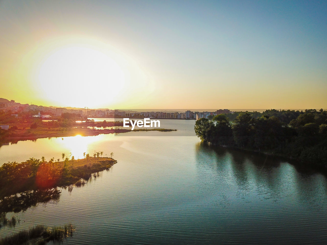 SCENIC VIEW OF RIVER AGAINST SKY DURING SUNSET