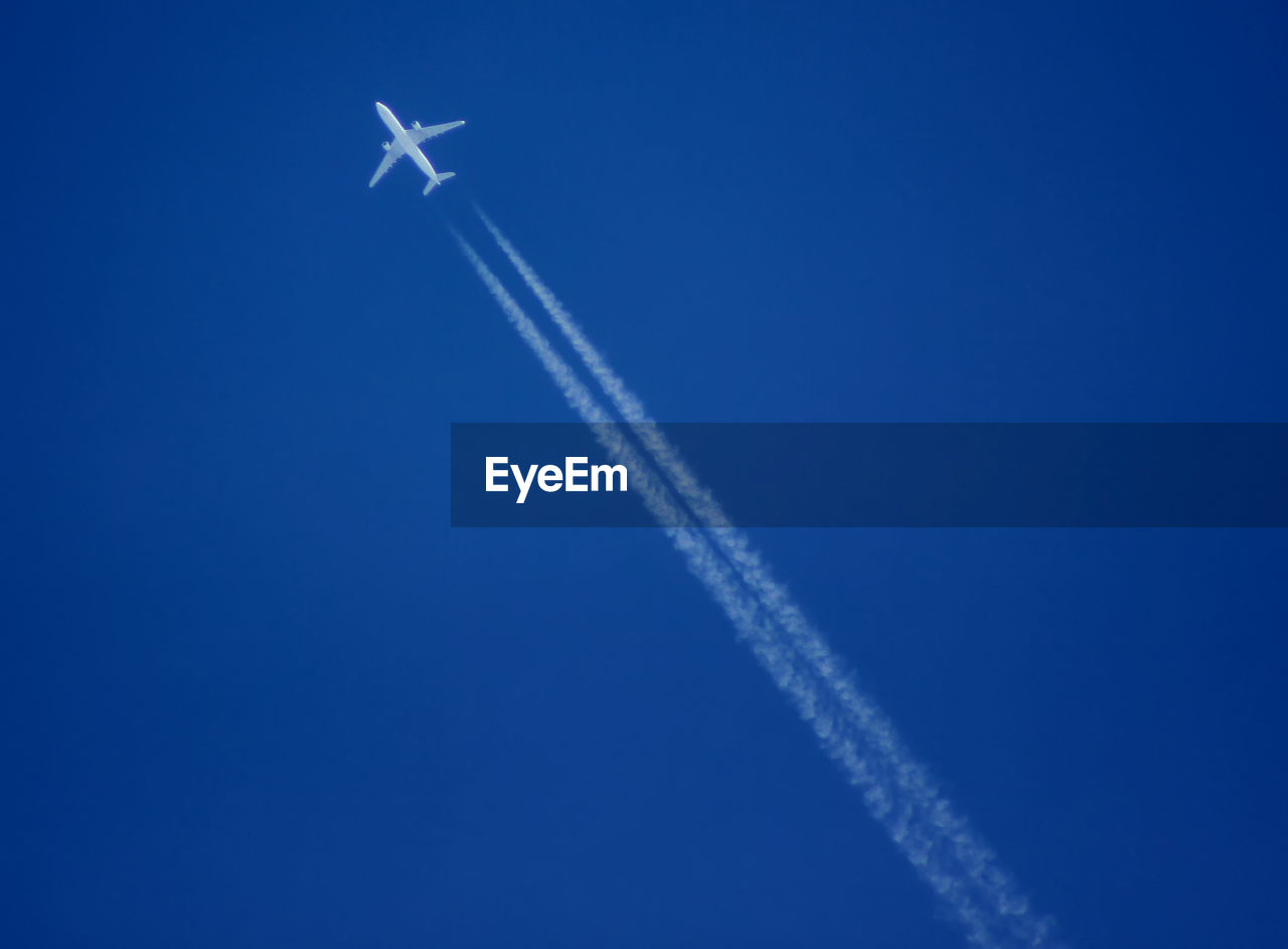 LOW ANGLE VIEW OF AIRPLANE FLYING IN SKY