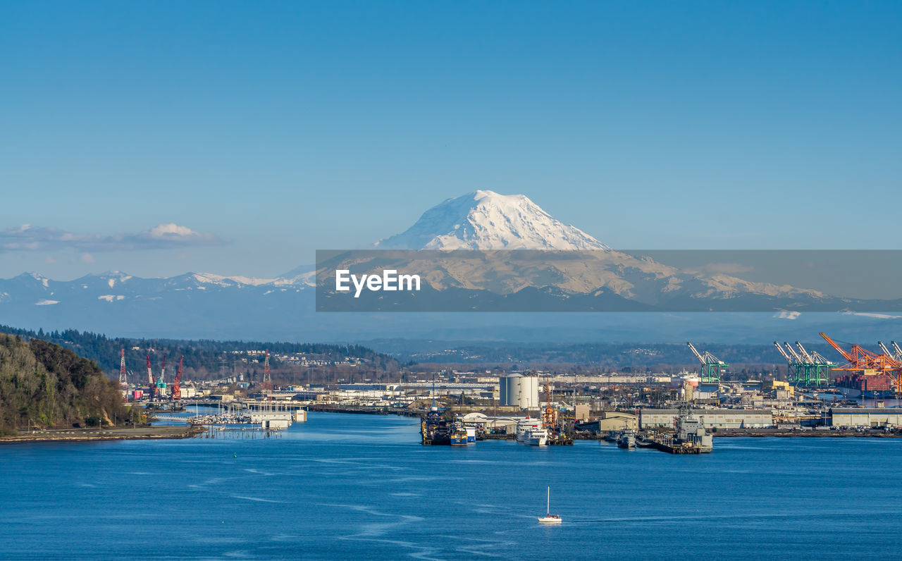 A view of the port of tacoma with mount rainier in the distance.