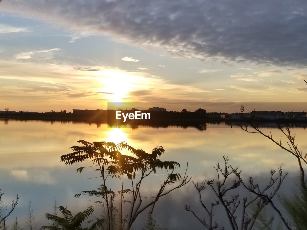 SCENIC VIEW OF LAKE AGAINST ORANGE SKY