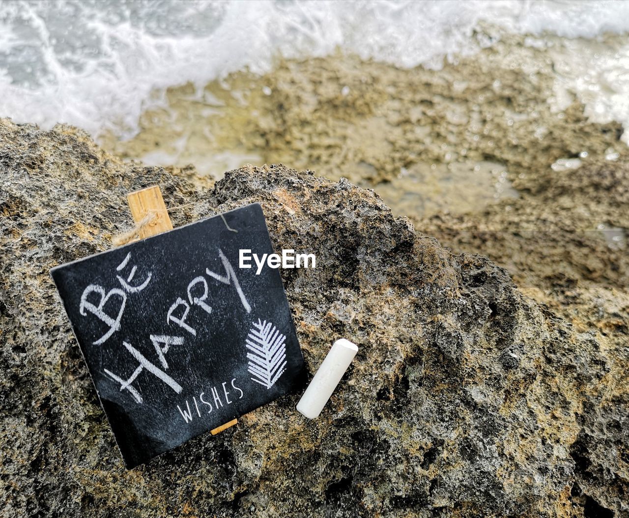 High angle view of text written on sand