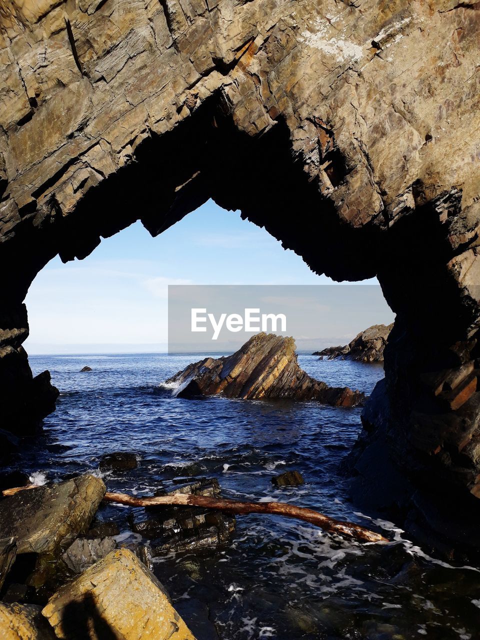 Scenic view of sea seen through cave