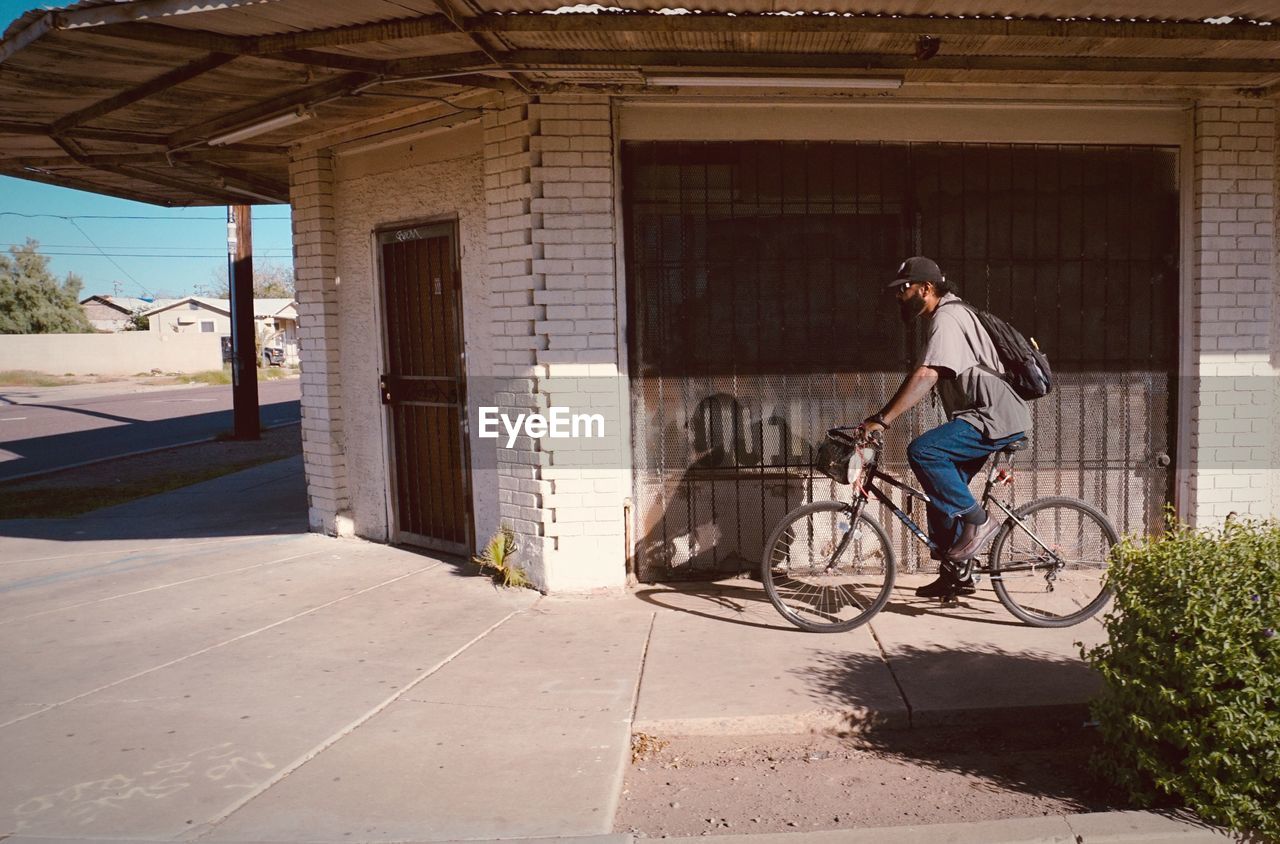 BICYCLE PARKED AGAINST BUILDING