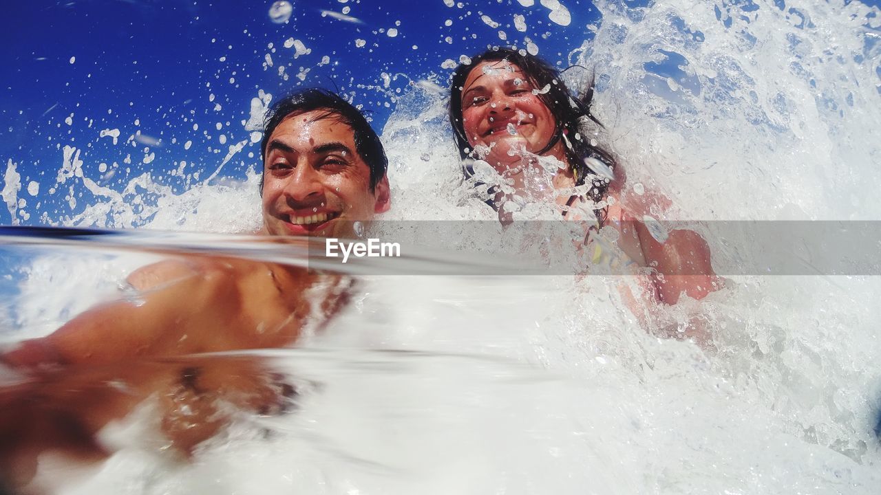 Close-up of people enjoying in water