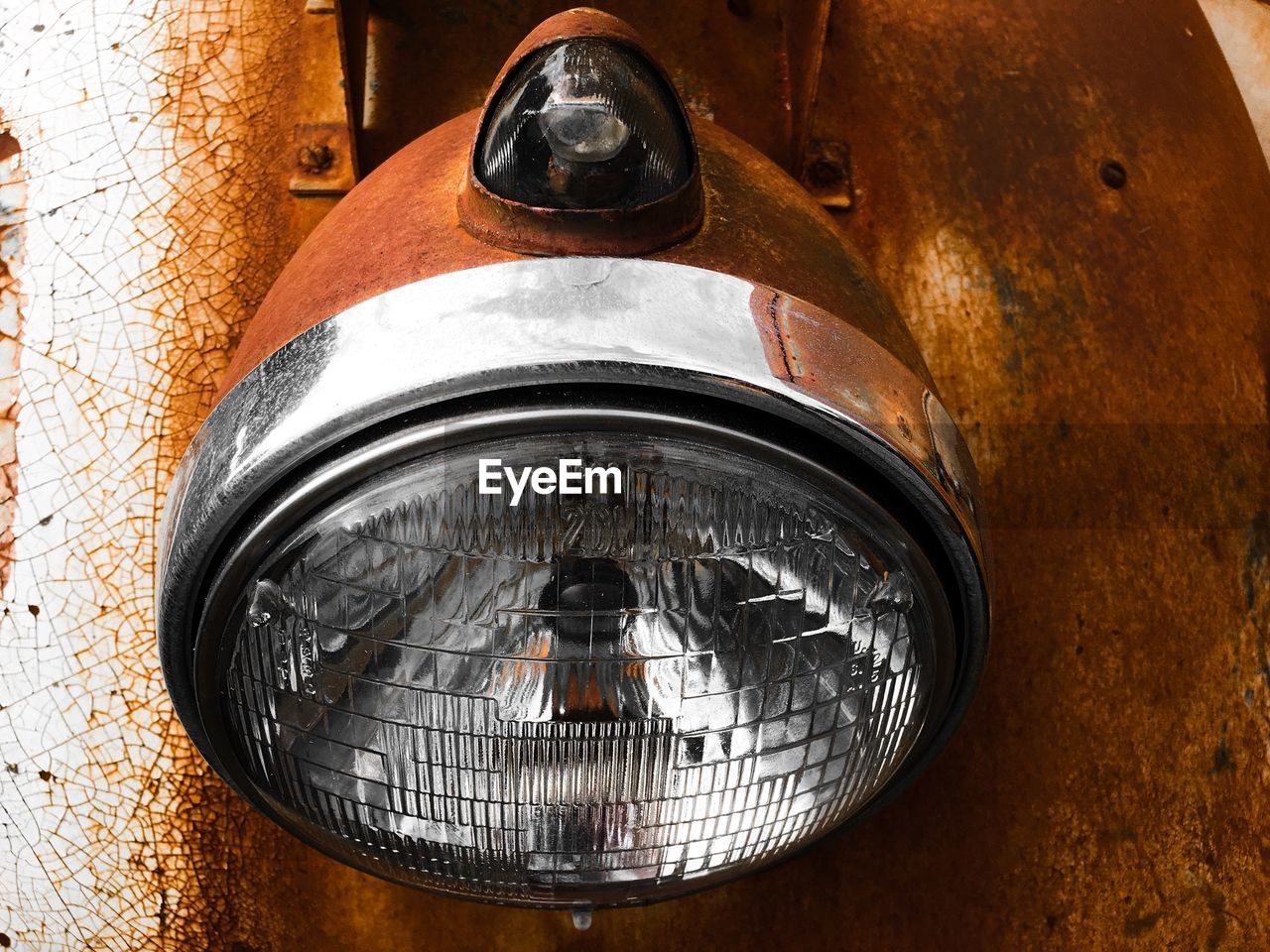 Close-up of headlight on rusty car