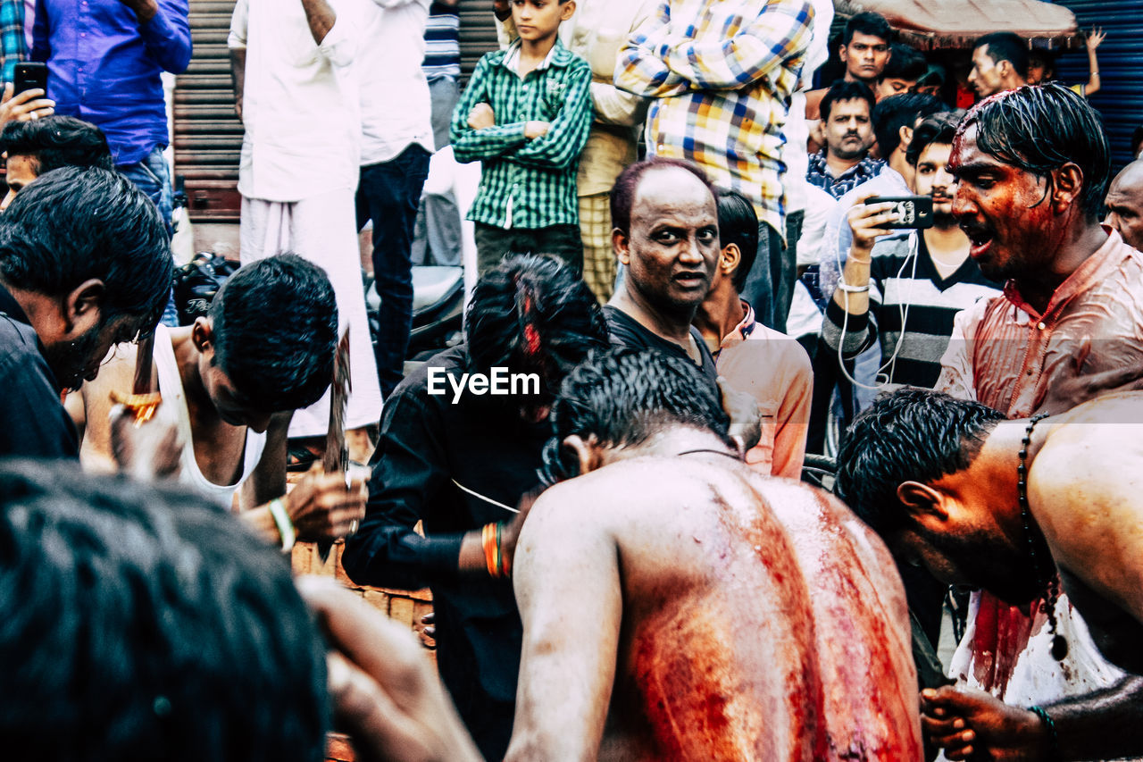 PEOPLE LOOKING AT MARKET STALL