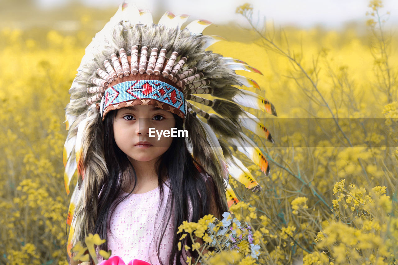 Portrait of girl amidst yellow flowers