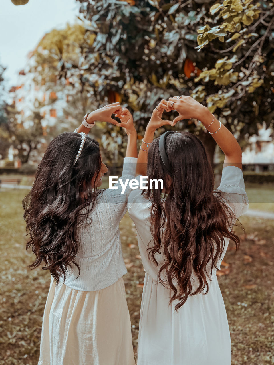 women, spring, adult, togetherness, bride, ceremony, rear view, two people, nature, hairstyle, female, dress, long hair, wedding dress, young adult, emotion, tree, brown hair, positive emotion, day, plant, happiness, bonding, arm, standing, outdoors, clothing, love, arms raised, child, friendship, waist up, autumn, focus on foreground, flower, celebration, childhood, leisure activity, romance, wedding, land, lifestyles, portrait, person, enjoyment, casual clothing