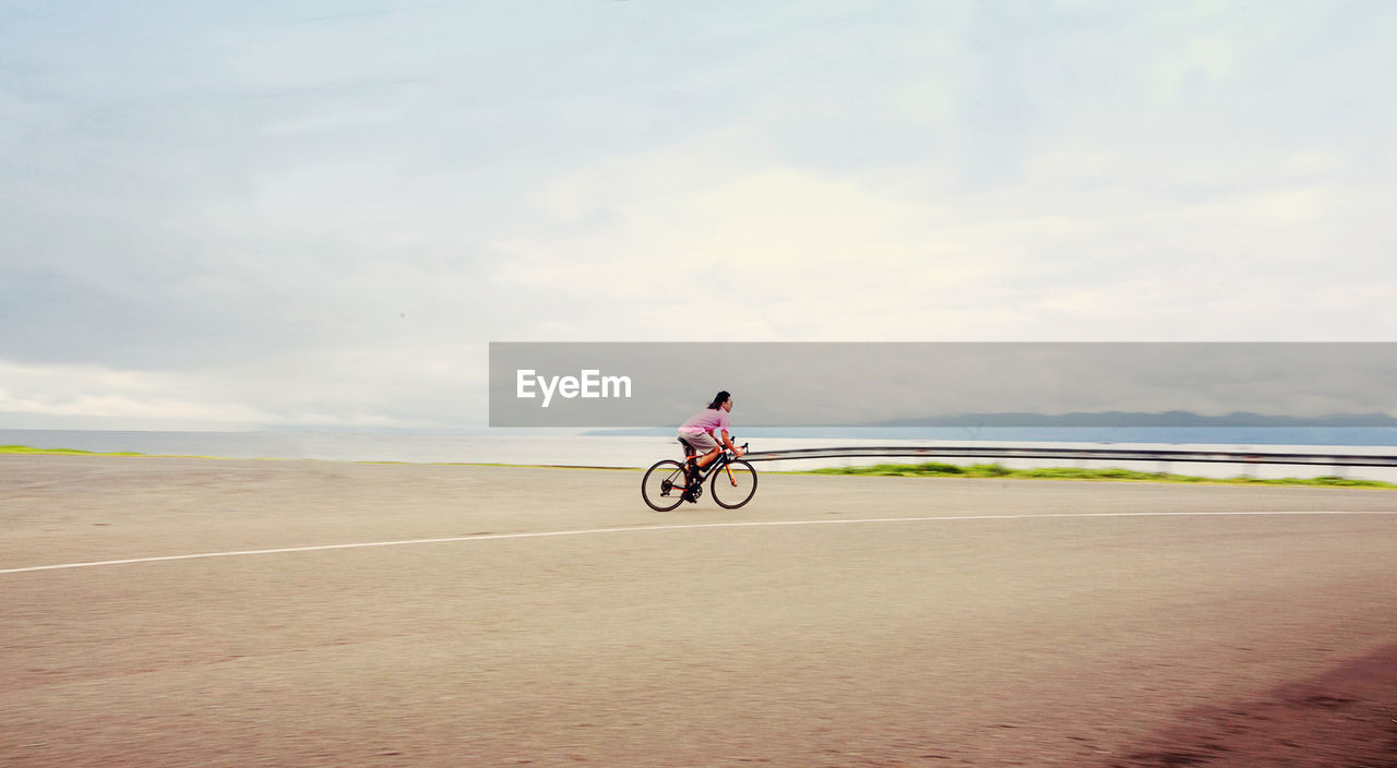 Man riding bicycle on road