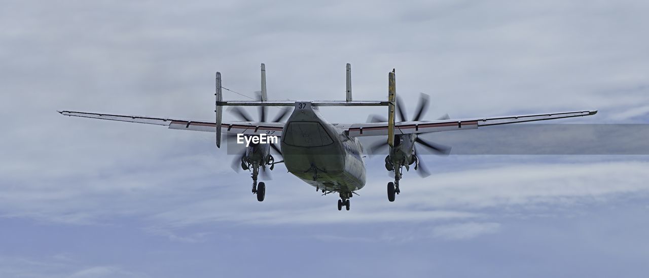 Low angle view of airplane flying against sky