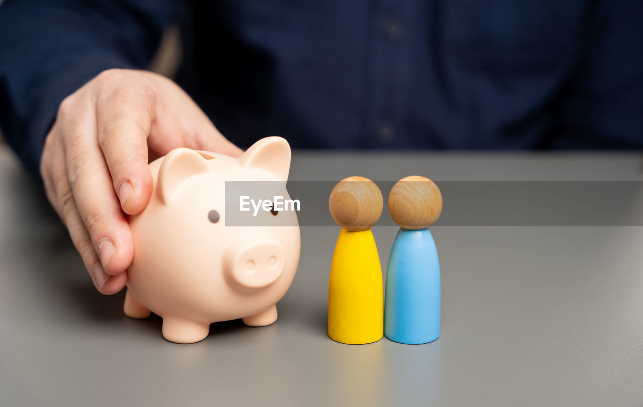 A man holds a piggy bank in his hands near people of ukrainian nationality. budget of ukraine 