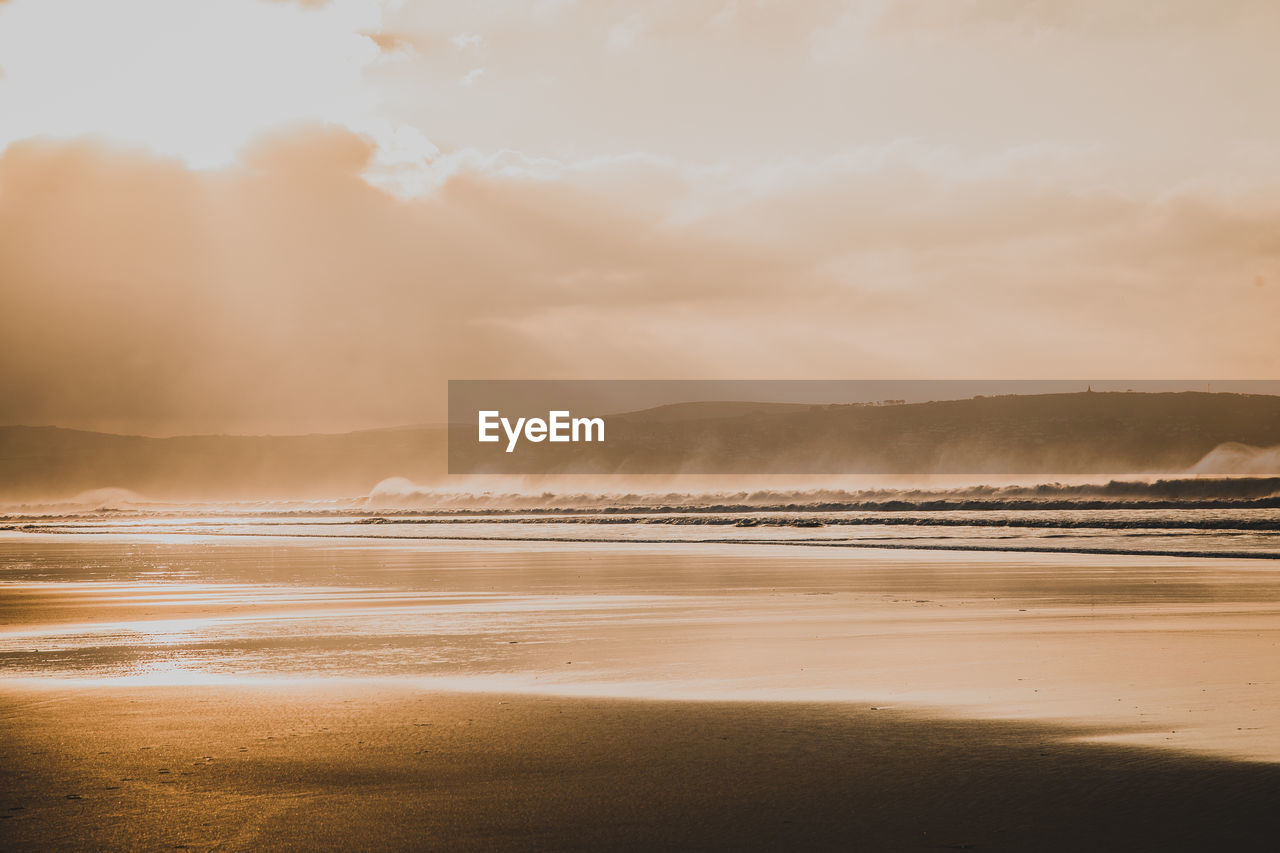 Scenic view of beach against sky during sunset