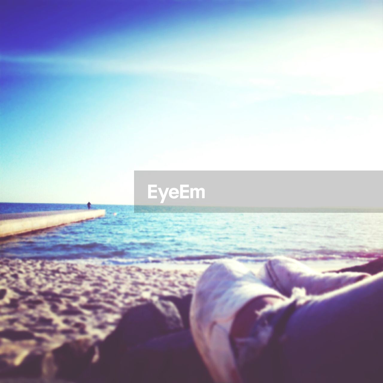 Low section of woman relaxing on beach