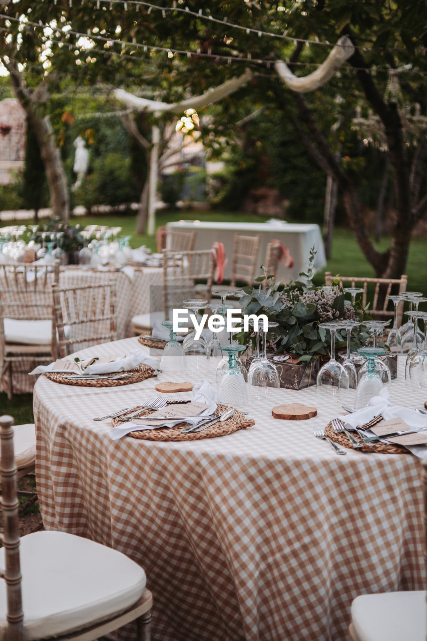 Empty chairs and tables in yard