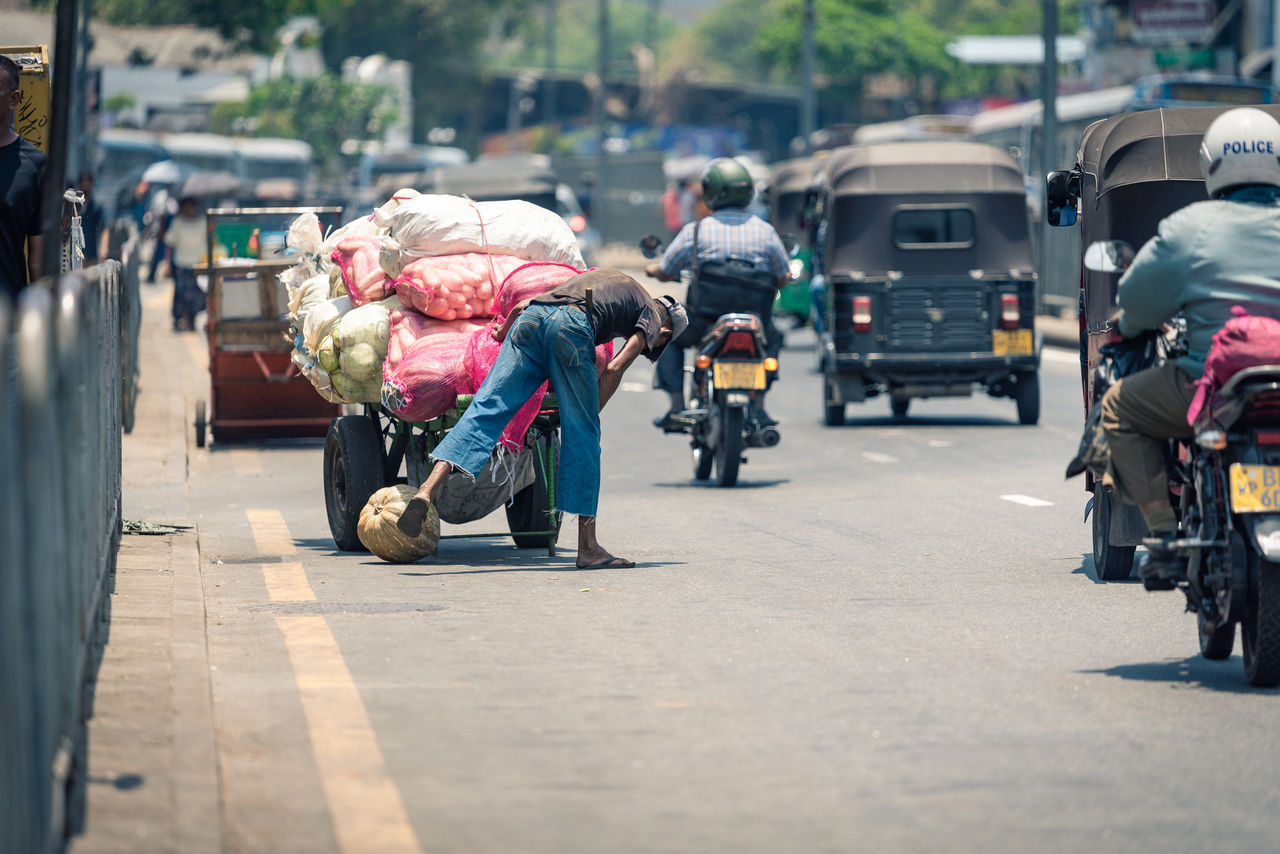 Rear view of man with market stall on street